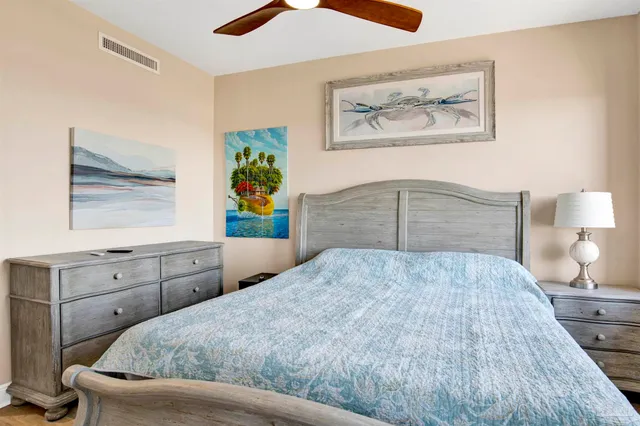 a bedroom with a bed and a painting on the wall