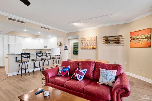 a living room with furniture and kitchen view