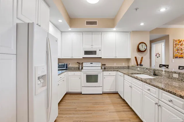 a kitchen with stainless steel appliances granite countertop a stove and a sink