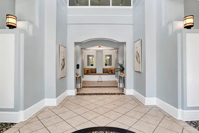 a view of a hallway with windows and livingroom