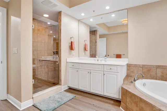 a bathroom with a shower a sink and a bathtub