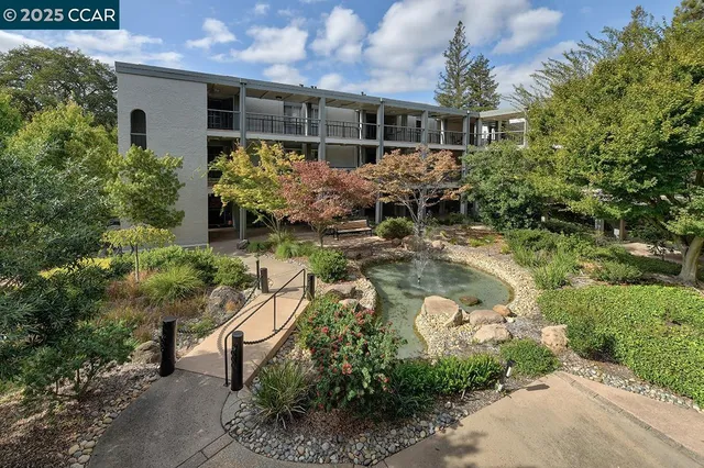 a backyard of a house with yard and outdoor seating