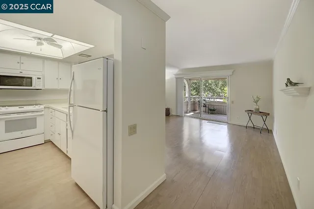 a kitchen with a sink appliances and cabinets