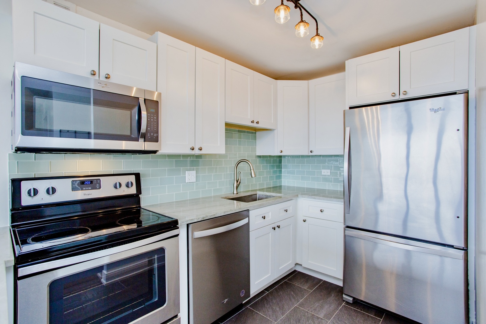 655 West Irving Park Road, Unit 4407 Chicago, IL 60613 - Photo 7 of 19 a kitchen with stainless steel appliances a refrigerator sink and cabinets