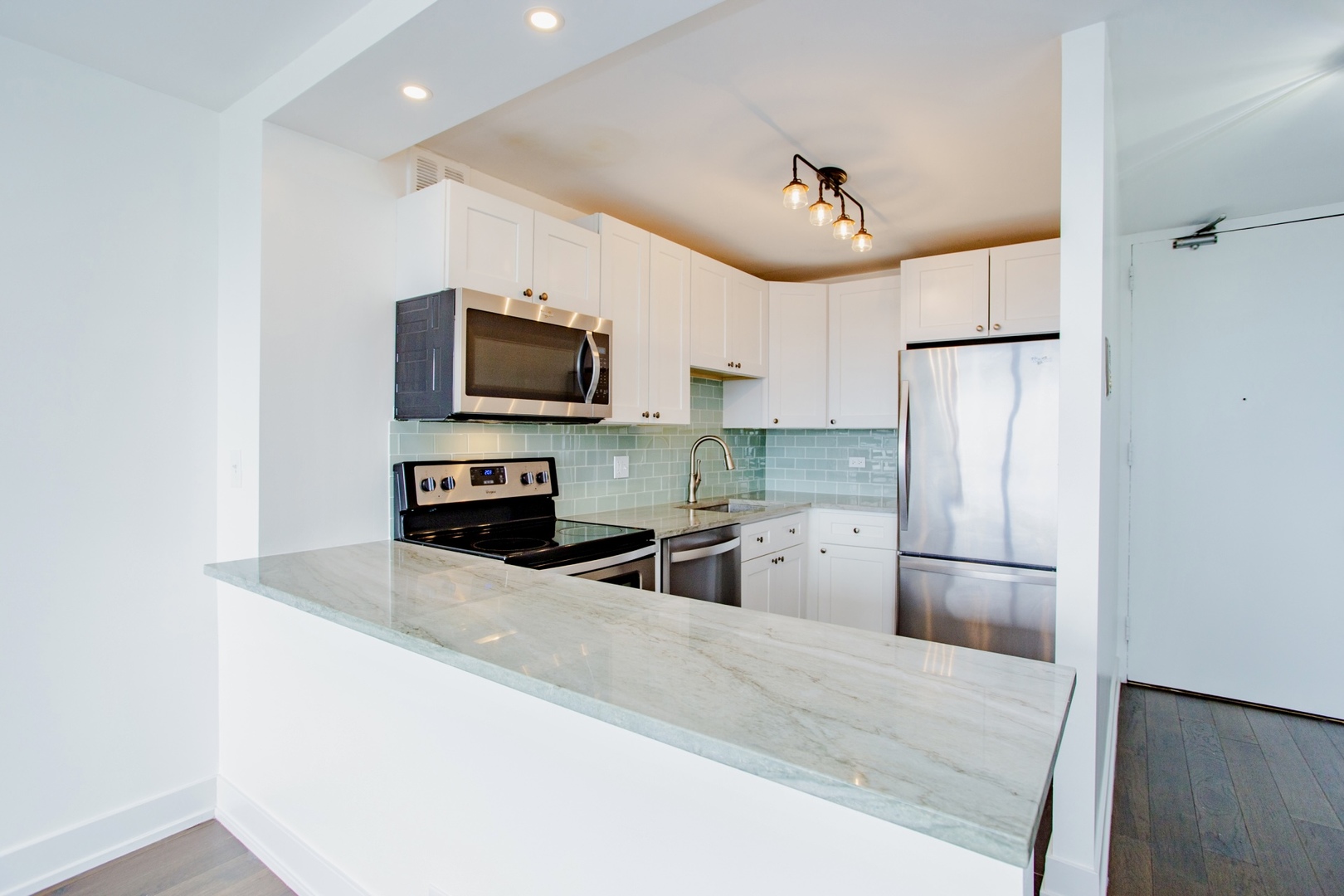 655 West Irving Park Road, Unit 4407 Chicago, IL 60613 - Photo 8 of 19 a kitchen with stainless steel appliances granite countertop a refrigerator a microwave a sink and a stove