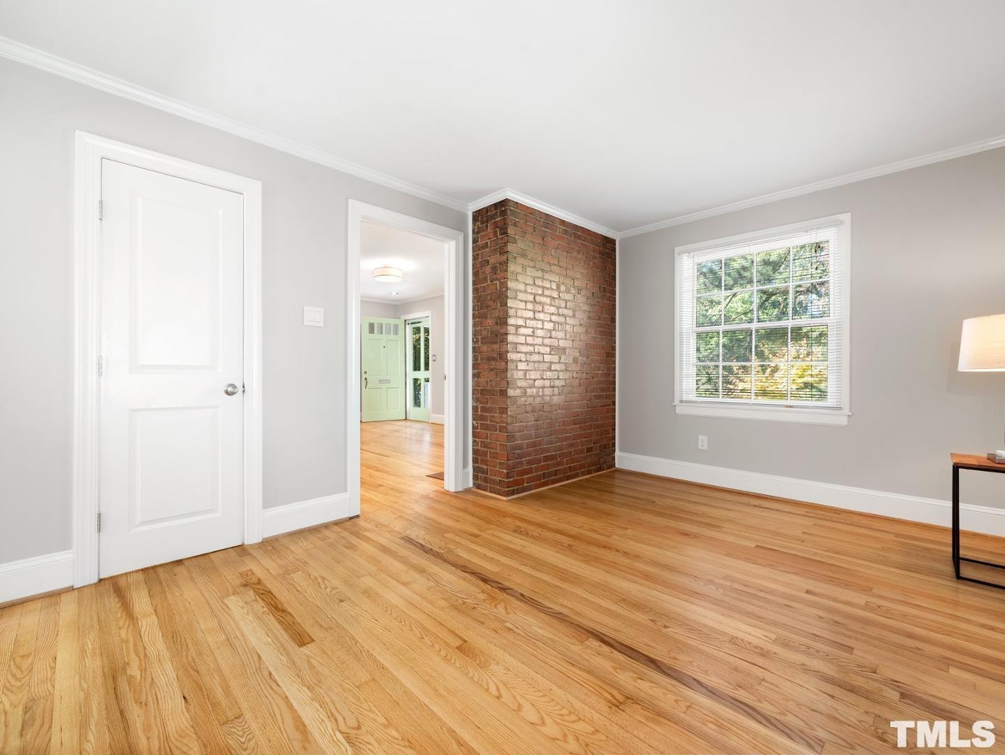 214 Faircloth Street Raleigh, NC 27607 - Photo 13 of 21 an empty room with wooden floor cabinet and windows