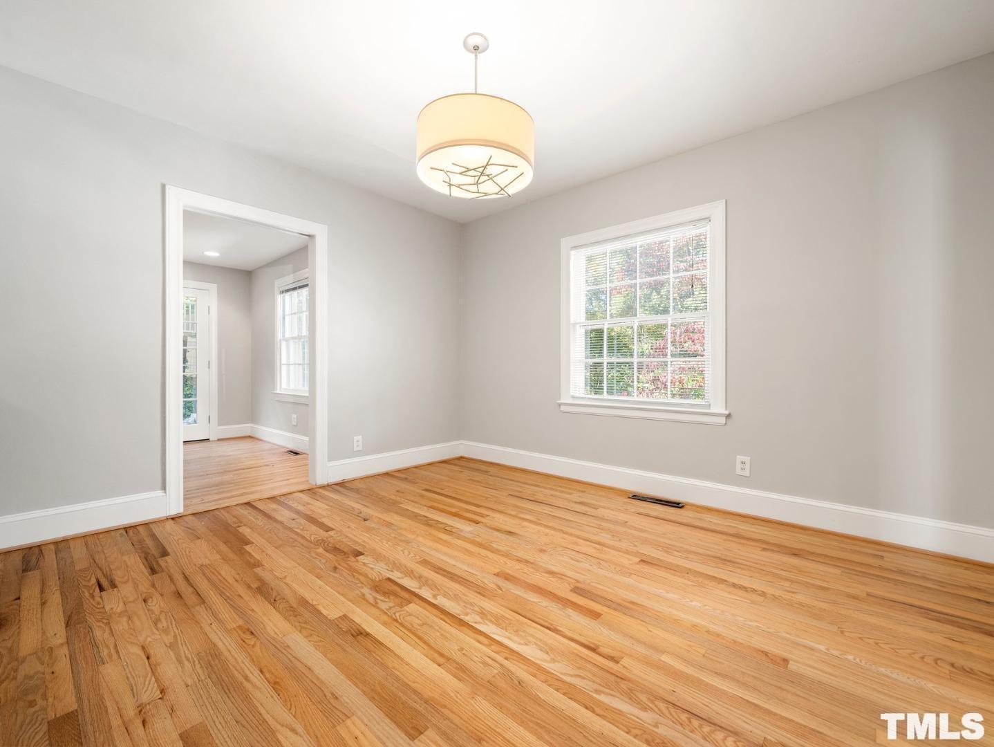 214 Faircloth Street Raleigh, NC 27607 - Photo 15 of 21 a view of an empty room with wooden floor and a window