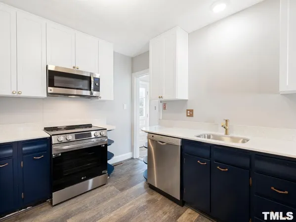 a kitchen with a sink and a stove top oven