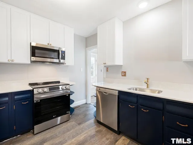 a kitchen with a sink and a stove top oven