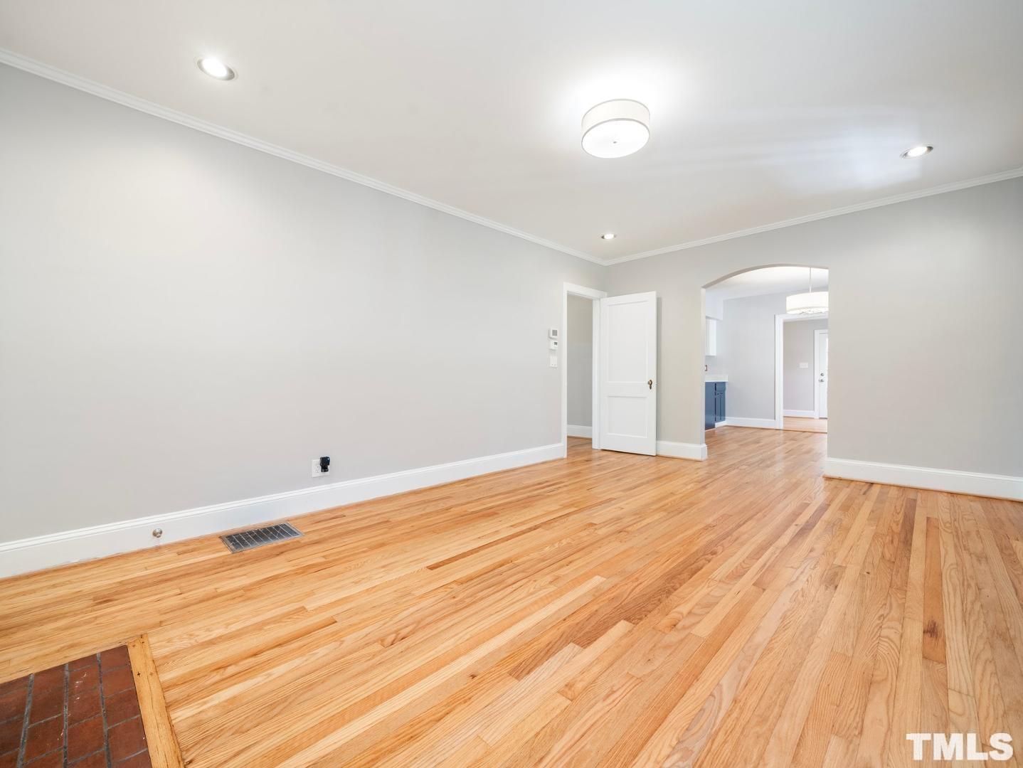214 Faircloth Street Raleigh, NC 27607 - Photo 10 of 21 a view of empty room with wooden floor and fan