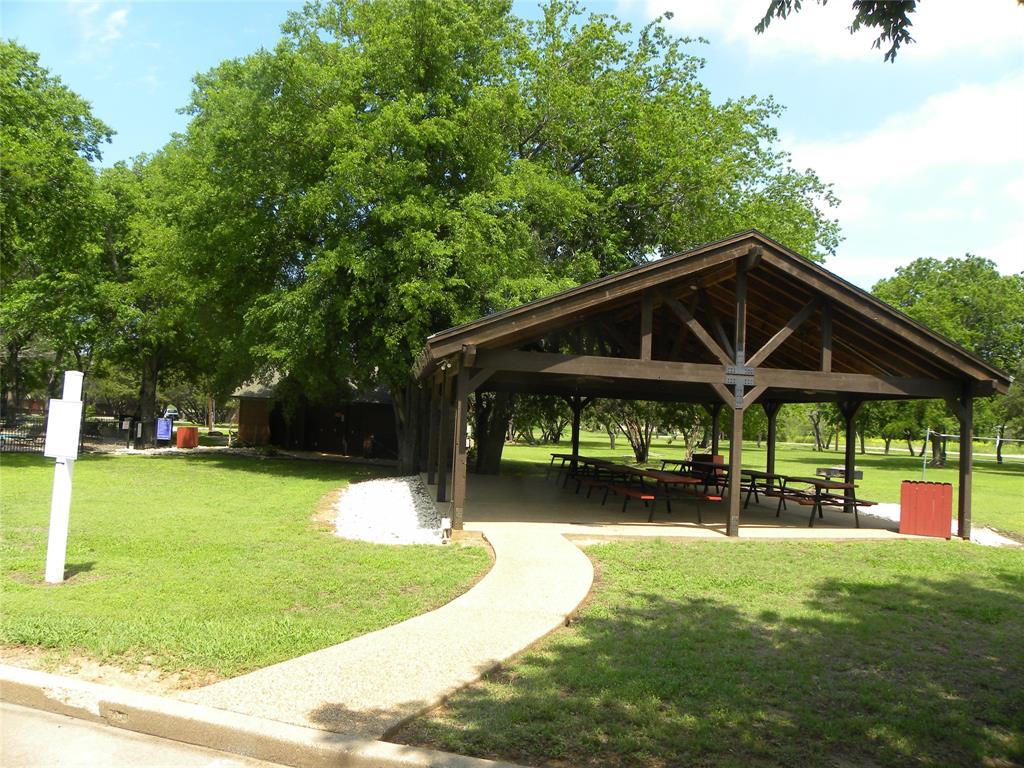 1303 Ash Court Whitney, TX 76692 - Photo 9 of 13 a backyard of a house with a swing table and chairs