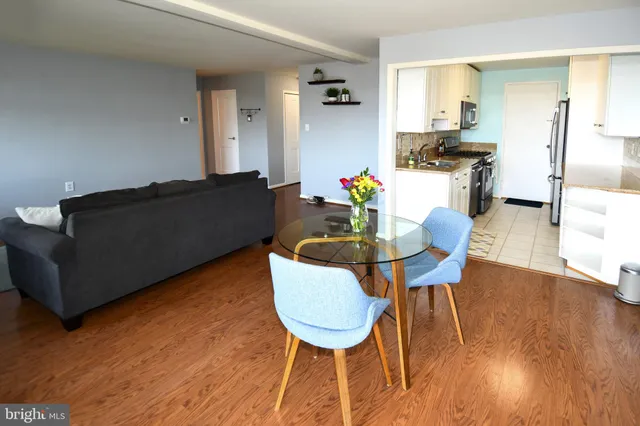a living room with dining room and wooden floor