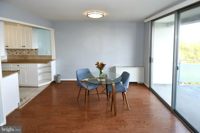 a dining room with furniture and wooden floor