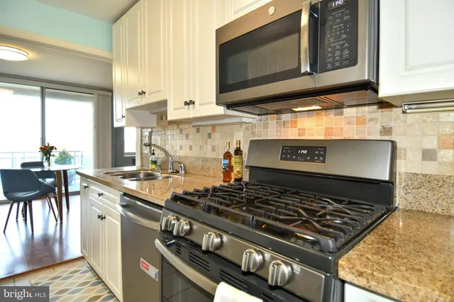 a stove top oven sitting inside of a kitchen