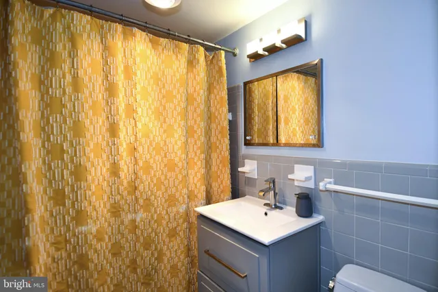 a bathroom with a sink vanity and a mirror