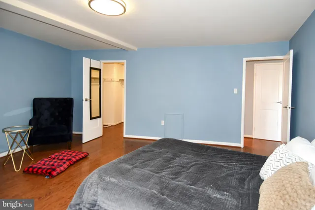 a bedroom with a bed and a chair