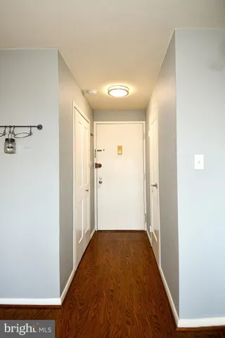 a view of a hallway with wooden floor