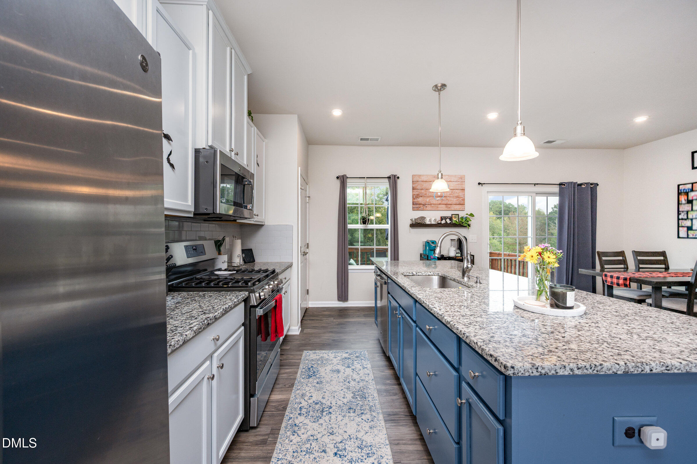 372 Amber Acorn Avenue Raleigh, NC 27603 - Photo 10 of 49 a large kitchen with kitchen island granite countertop a large center island and a sink