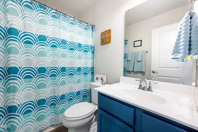 a bathroom with a sink a mirror and shower