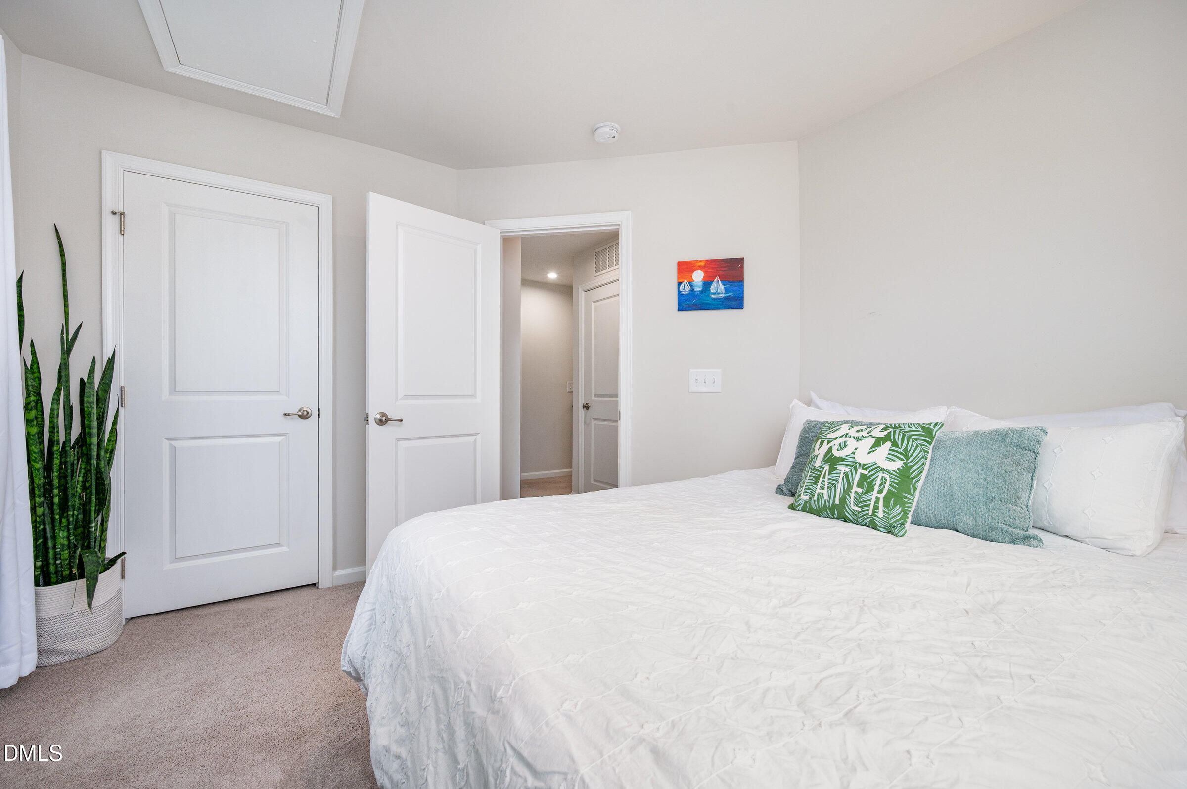 372 Amber Acorn Avenue Raleigh, NC 27603 - Photo 17 of 49 a bedroom with a bed and a potted plant