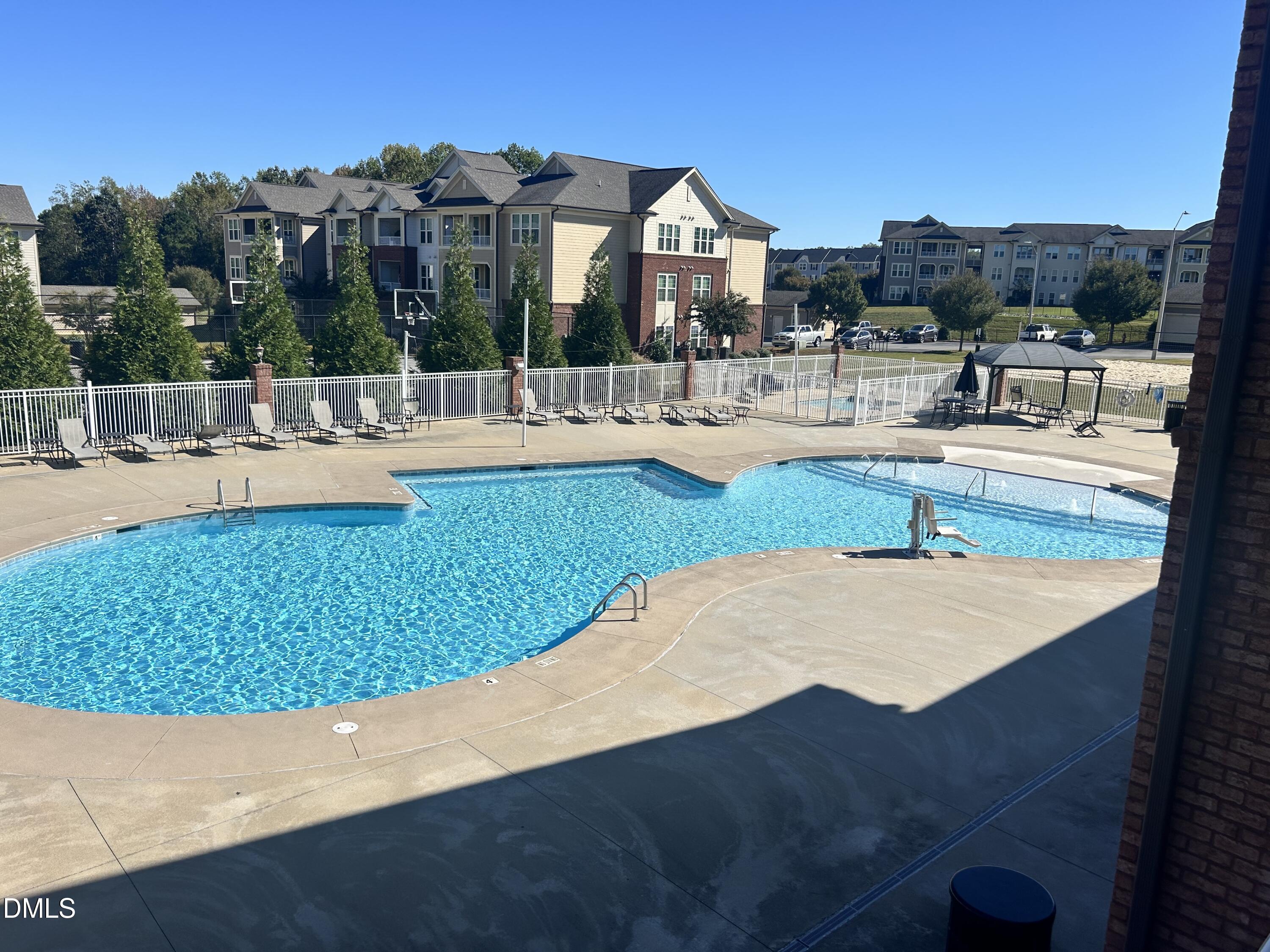 372 Amber Acorn Avenue Raleigh, NC 27603 - Photo 26 of 49 a view of a swimming pool with outdoor seating