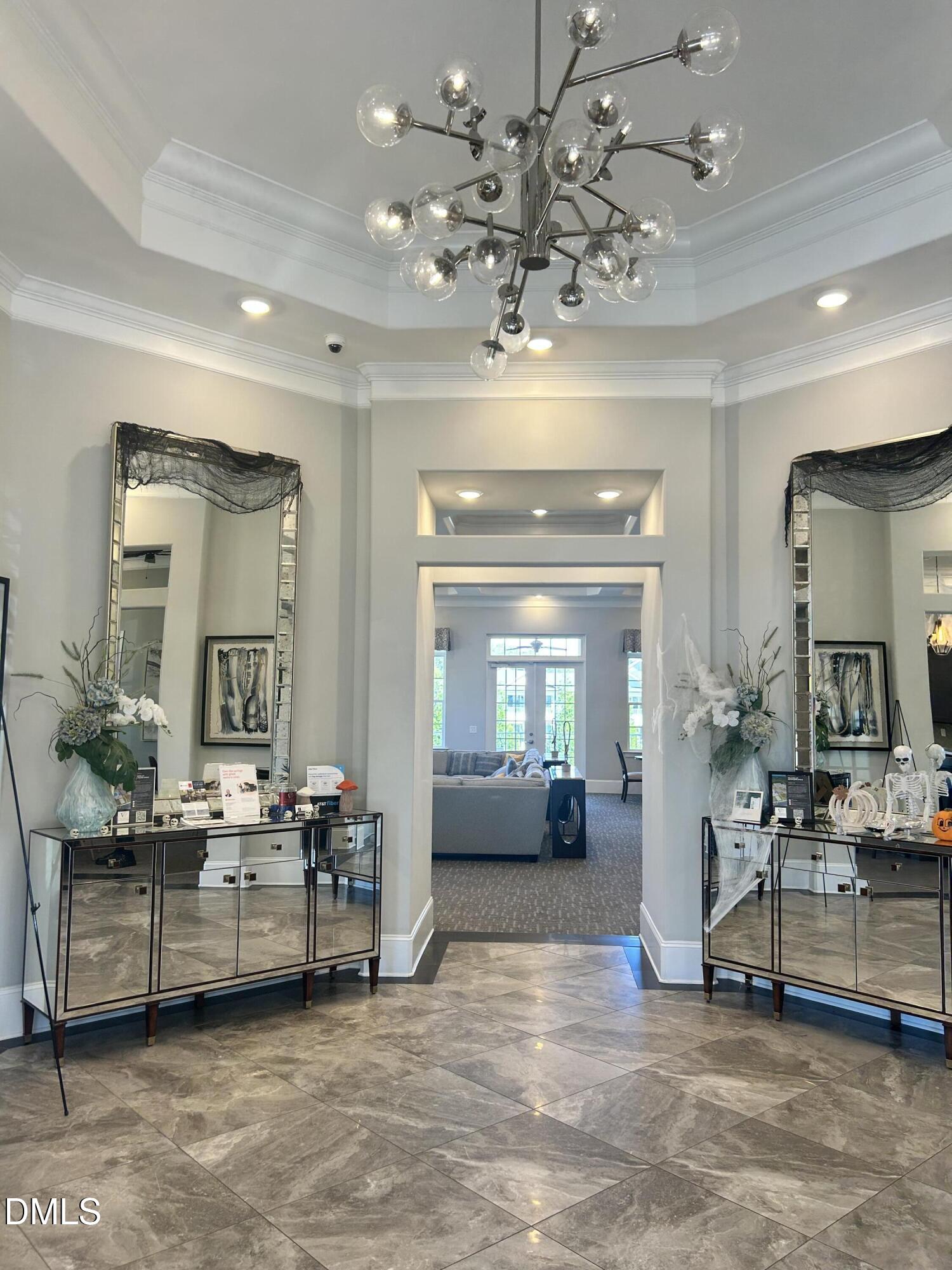 372 Amber Acorn Avenue Raleigh, NC 27603 - Photo 32 of 49 a view of a lobby with furniture and a chandelier