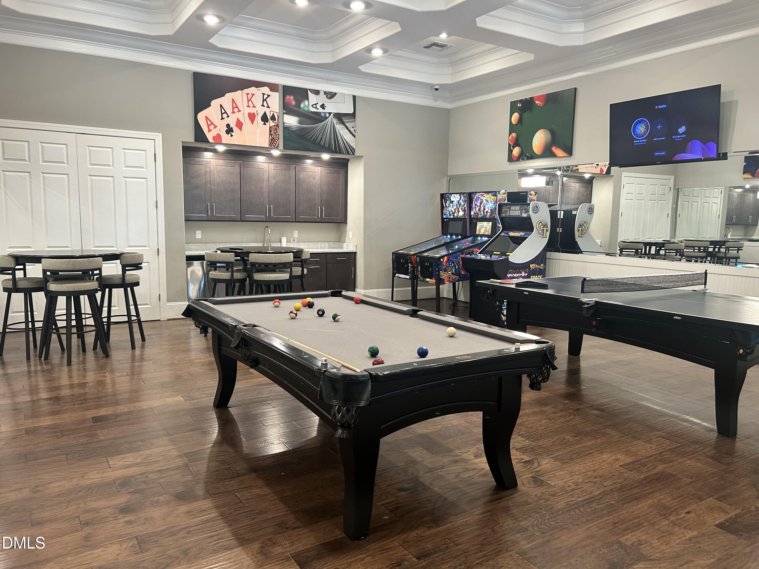 372 Amber Acorn Avenue Raleigh, NC 27603 - Photo 35 of 49 a room with a table chairs and a flat screen tv