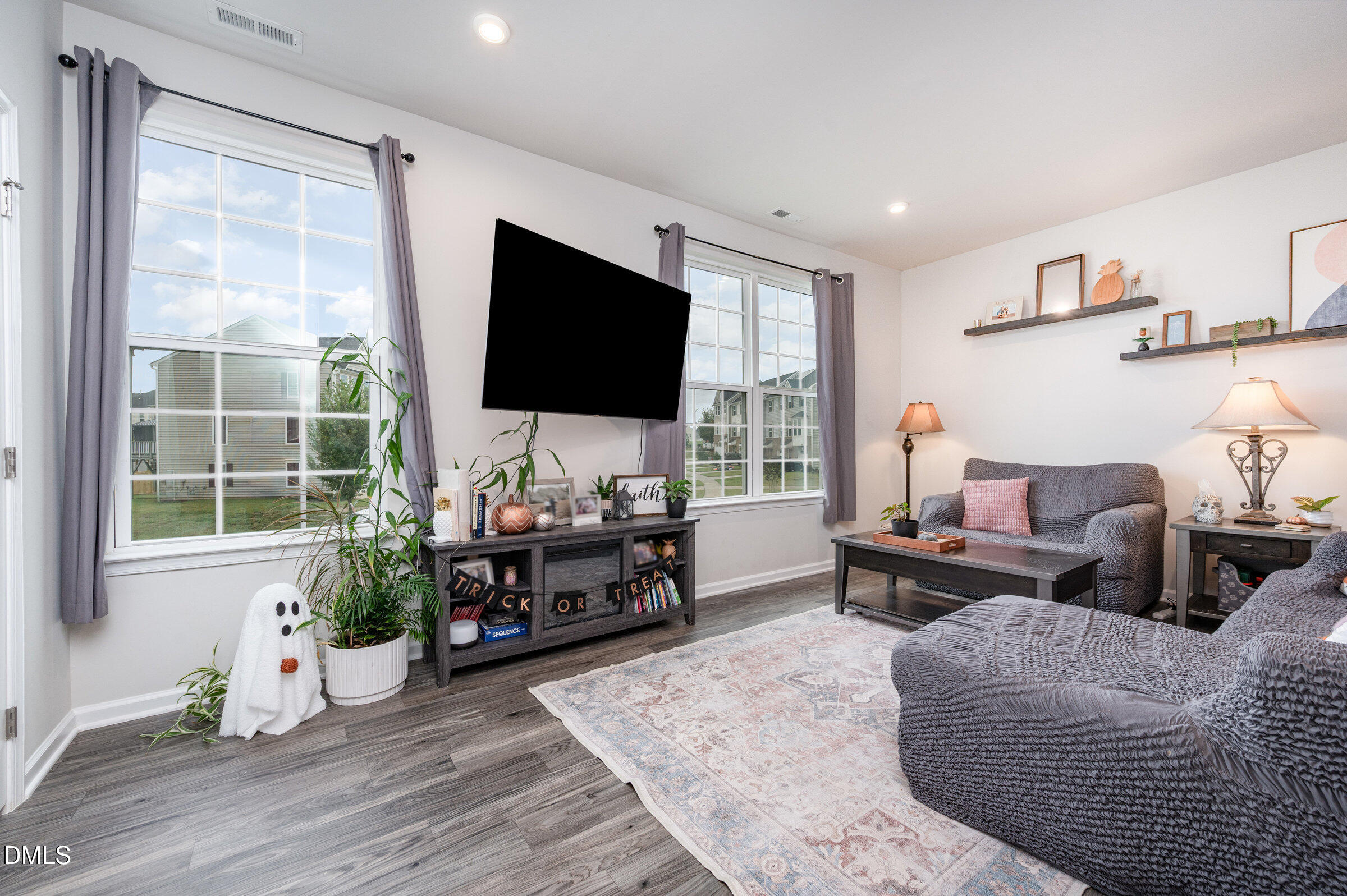 372 Amber Acorn Avenue Raleigh, NC 27603 - Photo 5 of 49 a living room with furniture or couch and a flat screen tv