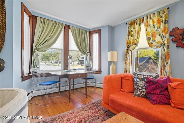 a living room with furniture a rug and a flat screen tv