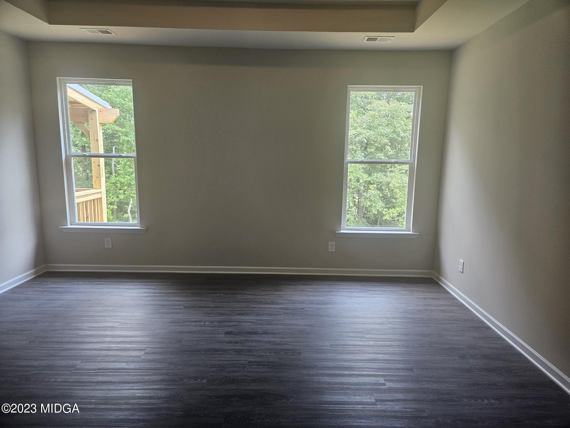 231 Presidents Way Forsyth, GA 31029 - Photo 13 of 32 an empty room with wooden floor and windows