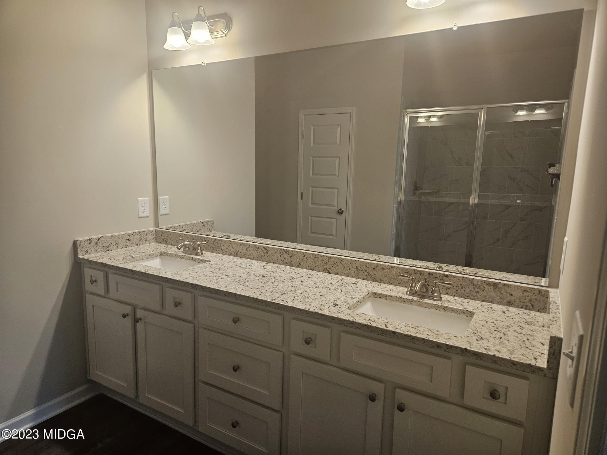 231 Presidents Way Forsyth, GA 31029 - Photo 14 of 32 a bathroom with a granite countertop sink and a mirror