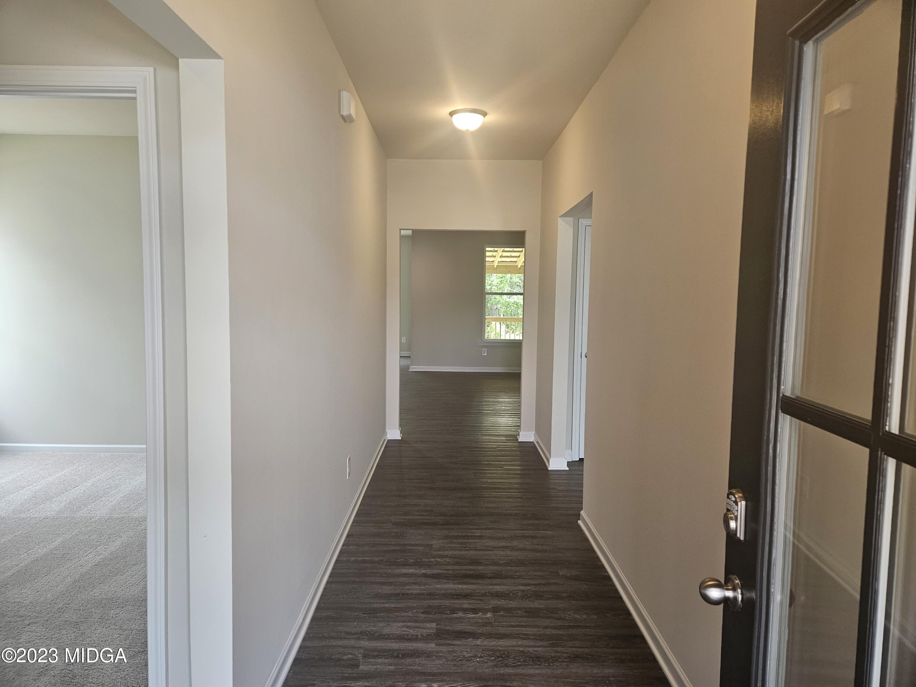 231 Presidents Way Forsyth, GA 31029 - Photo 2 of 32 a view of a hallway with wooden floor