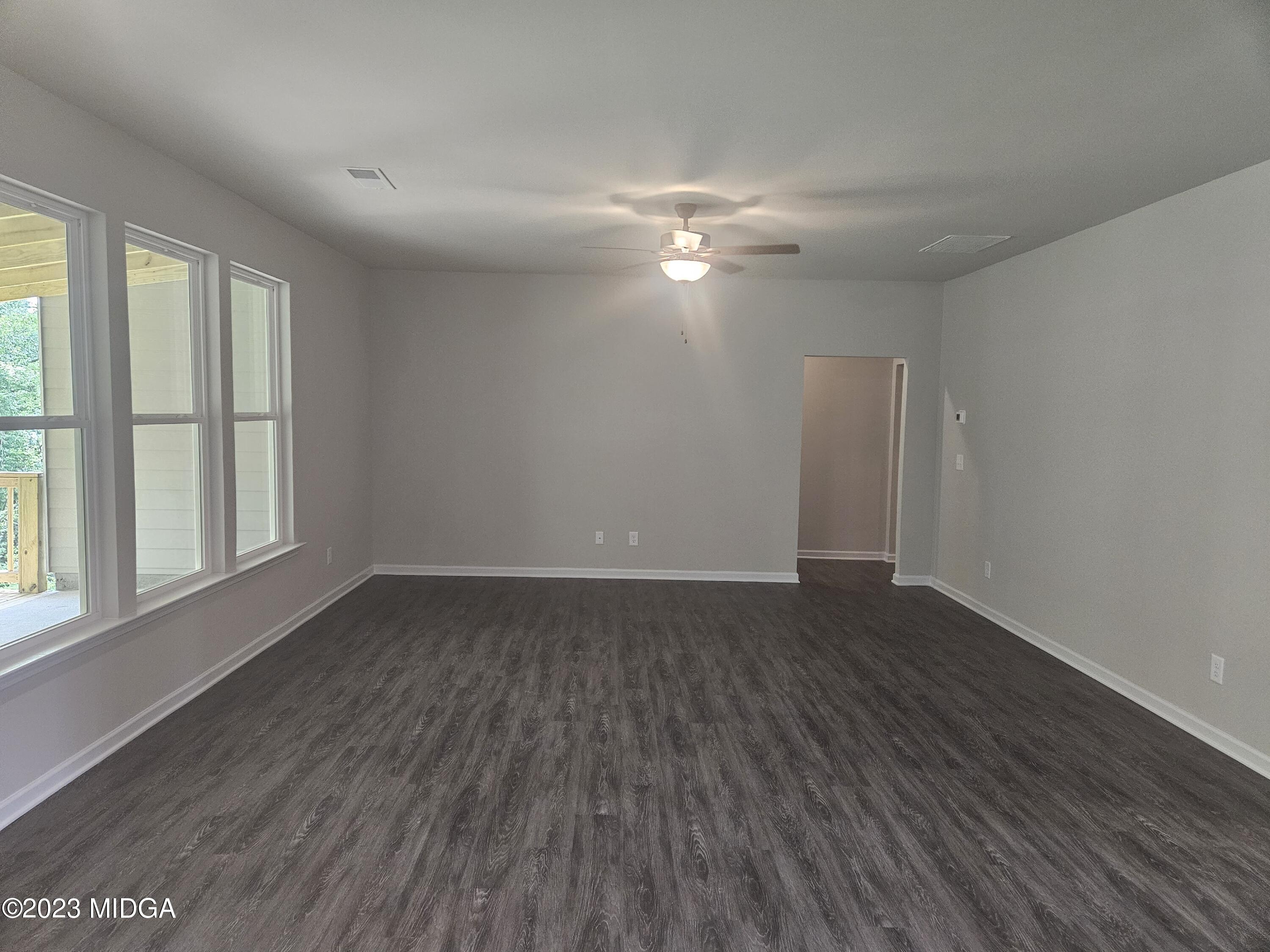 231 Presidents Way Forsyth, GA 31029 - Photo 10 of 32 a view of empty room with wooden floor and fan