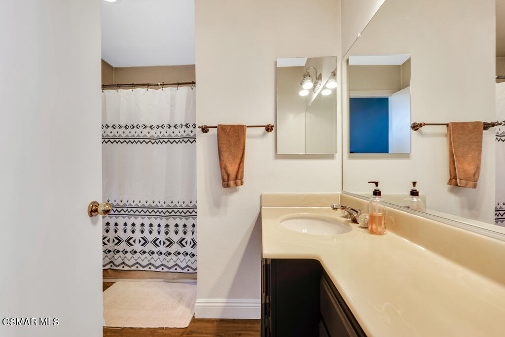 1854 Rory Lane, Unit 6 Simi Valley, CA 93063 - Photo 20 of 26 a bathroom with a sink and a mirror