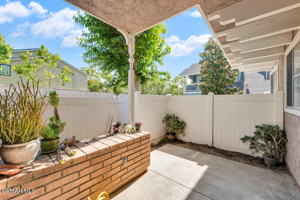 1854 Rory Lane, Unit 6 Simi Valley, CA 93063 - Photo 22 of 26 a wooden bench sitting in front of a house