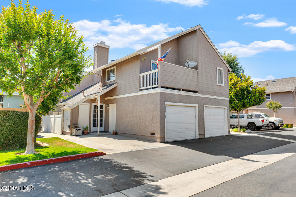1854 Rory Lane, Unit 6 Simi Valley, CA 93063 - Photo 3 of 26 a front view of a house with a yard and garage
