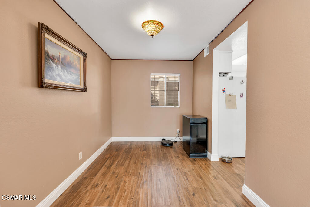 1854 Rory Lane, Unit 6 Simi Valley, CA 93063 - Photo 7 of 26 a view of a hallway with wooden floor and a bathroom