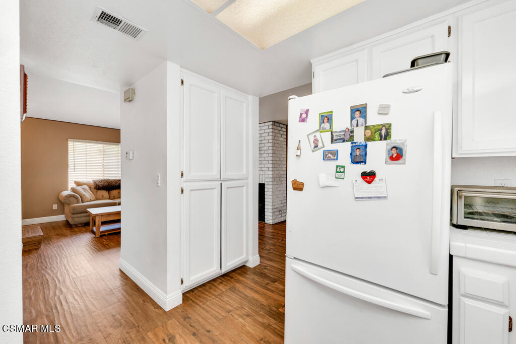 1854 Rory Lane, Unit 6 Simi Valley, CA 93063 - Photo 10 of 26 a white refrigerator freezer sitting in a kitchen