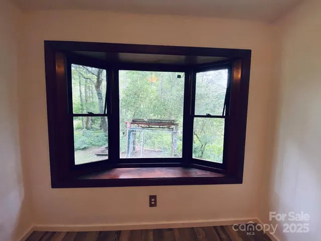 a view of an empty room and wooden floor