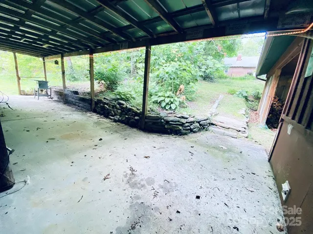 a view of a fire pit with large trees