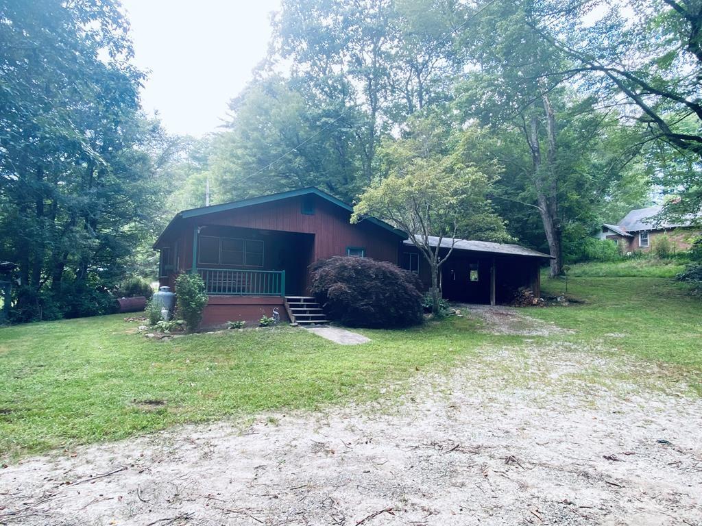 15 Valor Road Glenville, NC 28736 - Photo 18 of 30 a view of a fire pit with large trees