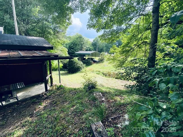 a view of a balcony with yard and sitting area
