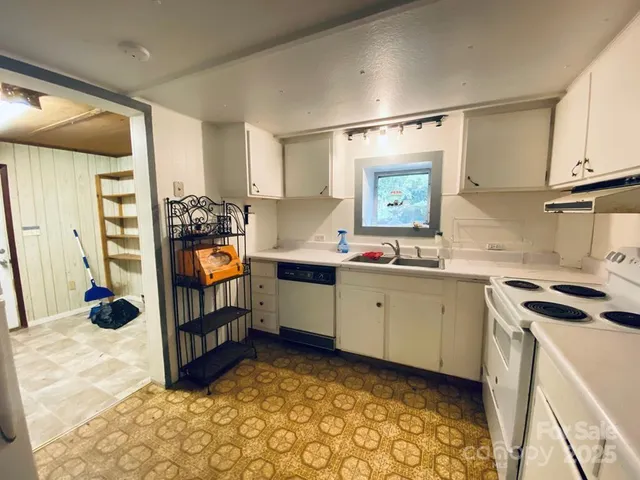 a kitchen with stainless steel appliances a stove a sink and a refrigerator