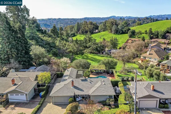 an aerial view of a house with garden space and street view