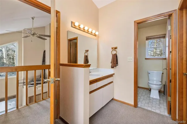 a bathroom with a walk in closet and wooden floor