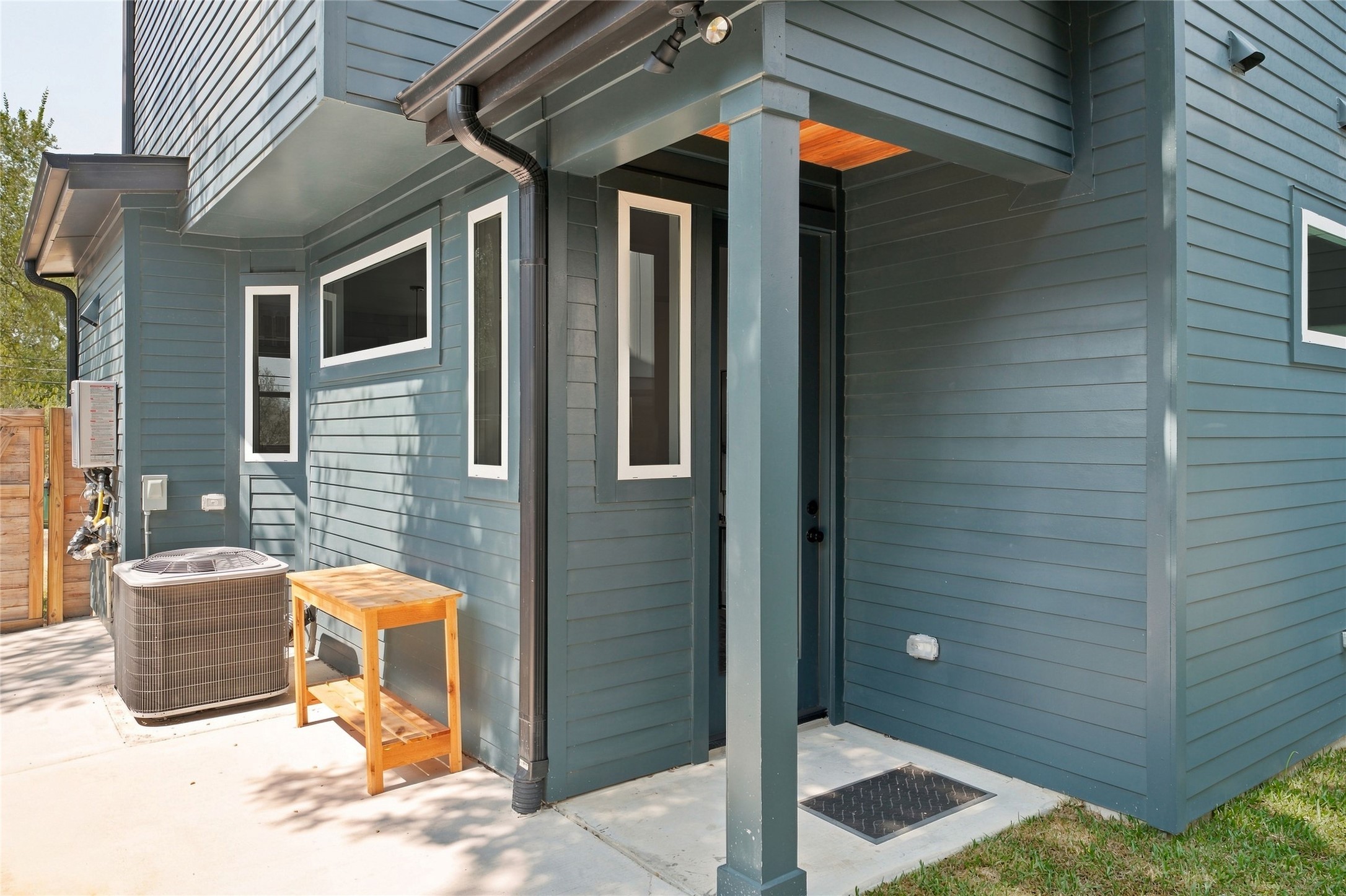 5506 Hudson Street, Unit 2 Austin, TX 78721 - Photo 12 of 24 A covered side entry from the backyard features the modern windows.