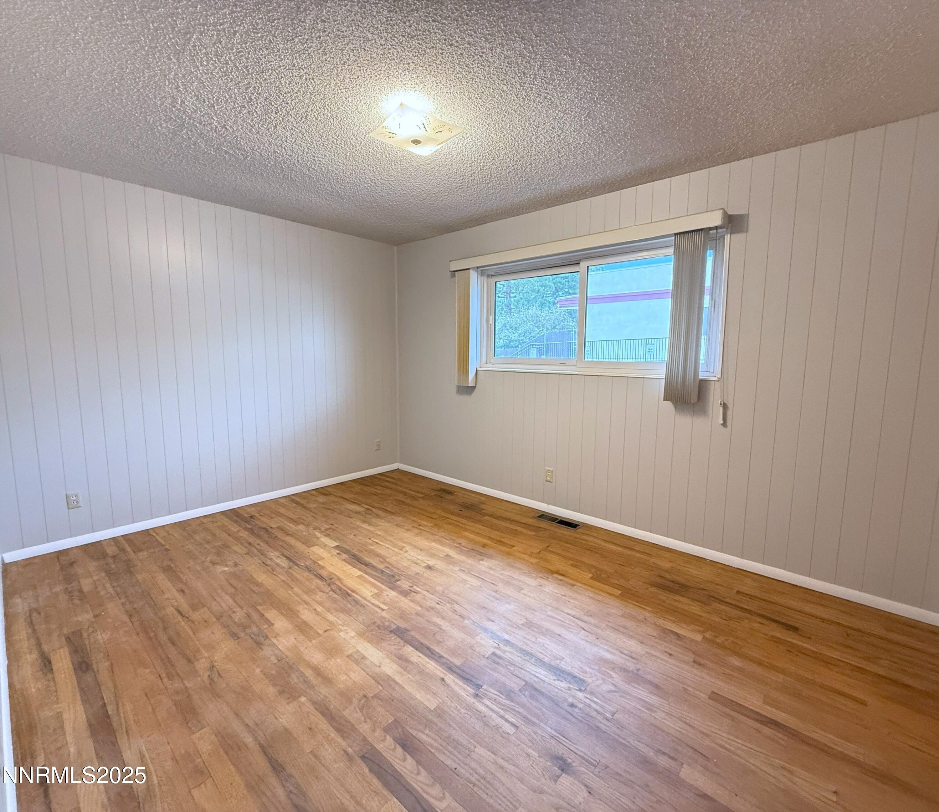1480 Grandview Avenue Reno, NV 89503 - Photo 14 of 42 a view of empty room with wooden floor and fan