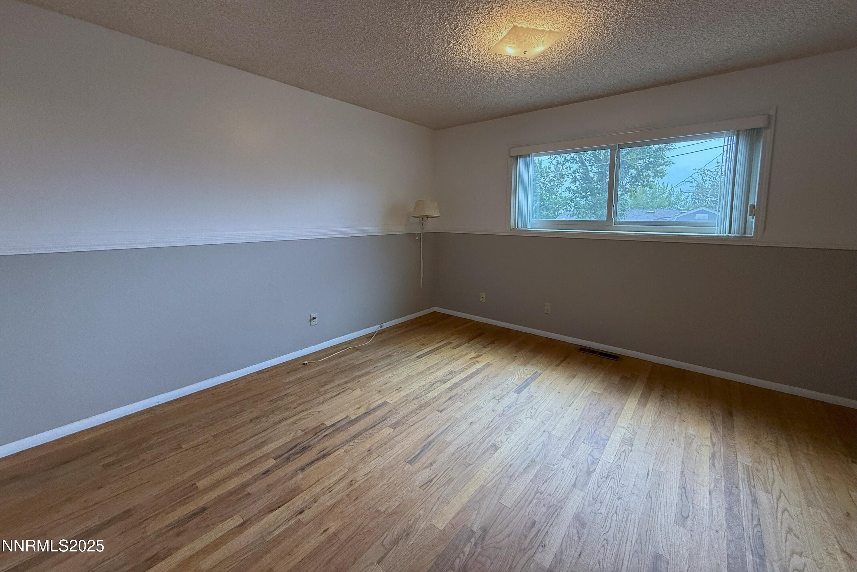 1480 Grandview Avenue Reno, NV 89503 - Photo 15 of 42 an empty room with wooden floor and windows