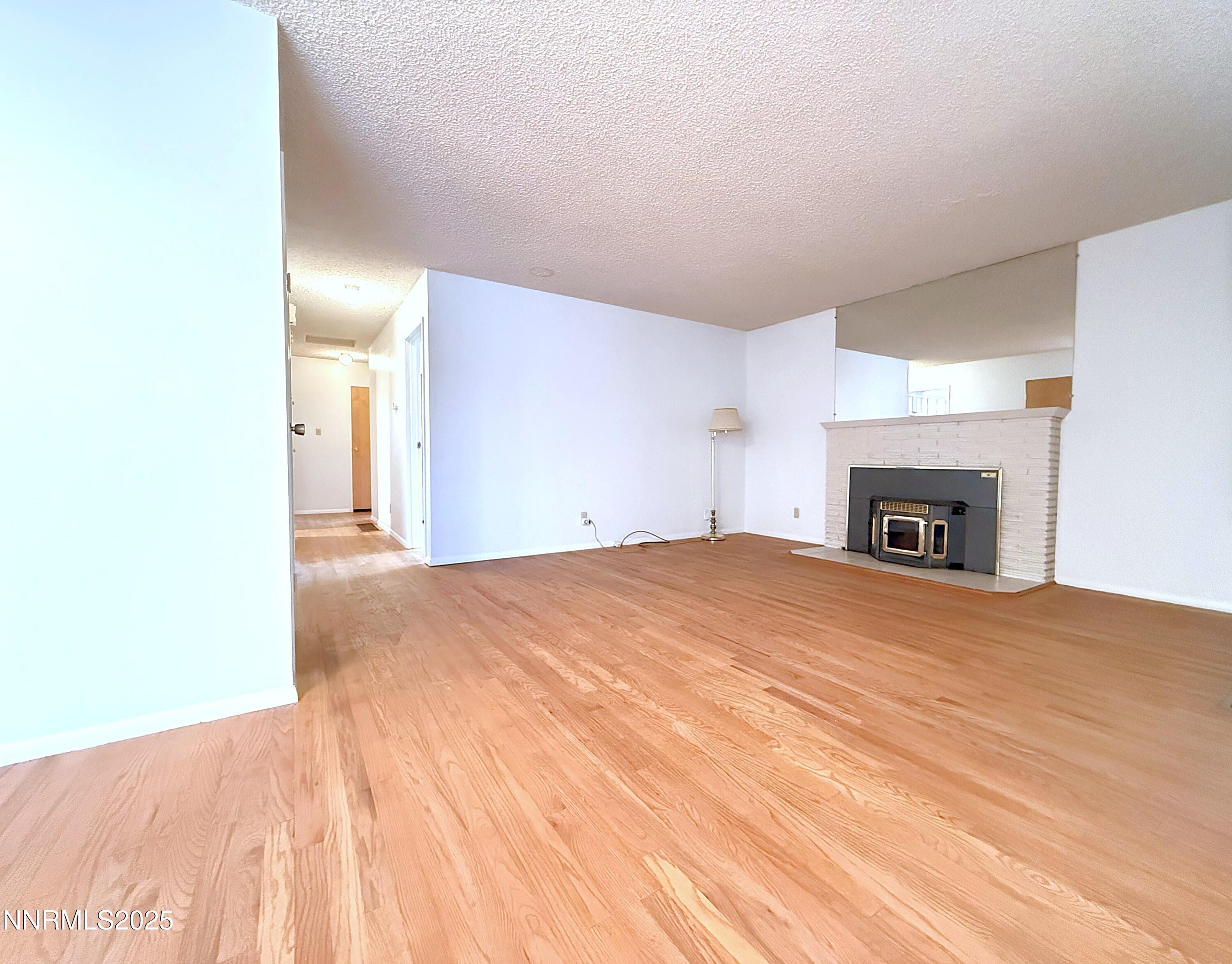 1480 Grandview Avenue Reno, NV 89503 - Photo 4 of 42 a view of empty room with a fireplace and wooden floor