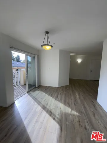 a view of an empty room and wooden floor